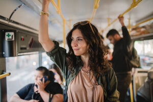 Woman looking out window while riding bus