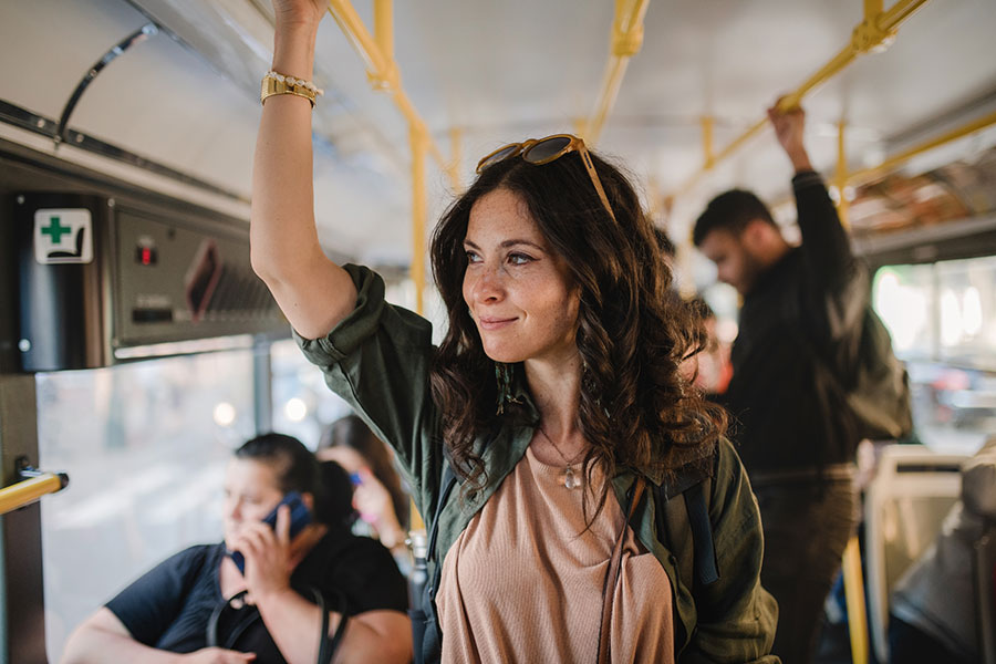 Woman looking out window while riding bus