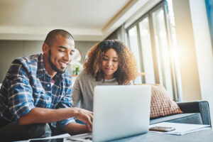 A young couple works together to manage finanacial accounts