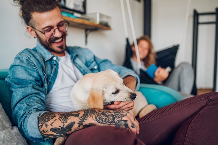 A man holds a newish puppy on his lap