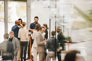 Group of cowrkers mingle at a social event