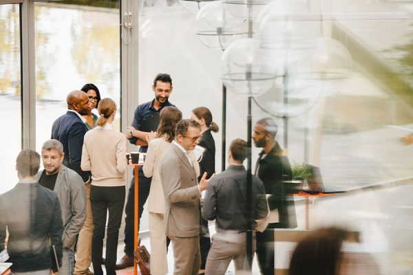 Group of cowrkers mingle at a social event