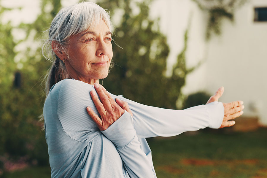 Woman stretching her arm outdoors